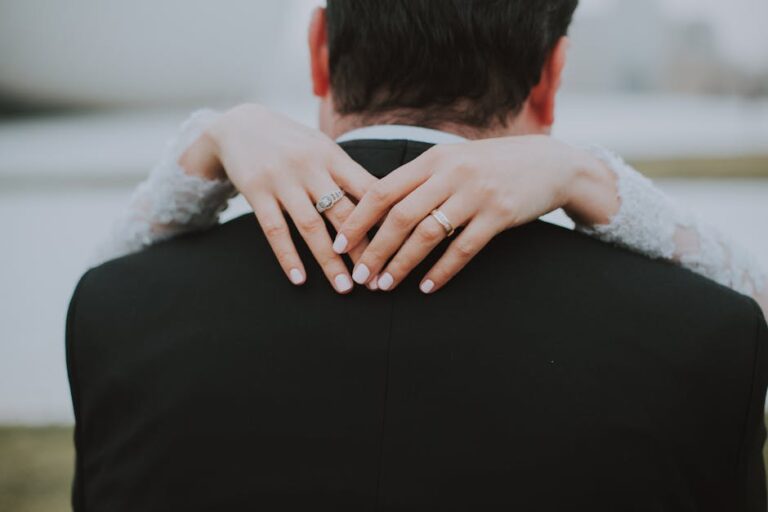 A close-up of a bride hugging a groom in an outdoor wedding ceremony in Baku.